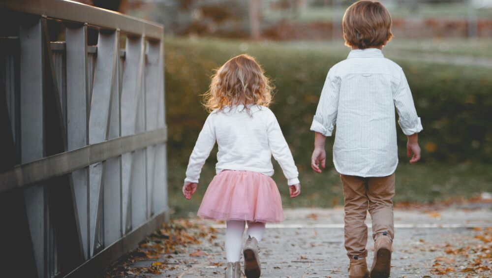 two siblings walking