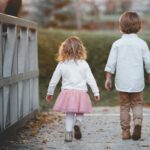 two siblings walking